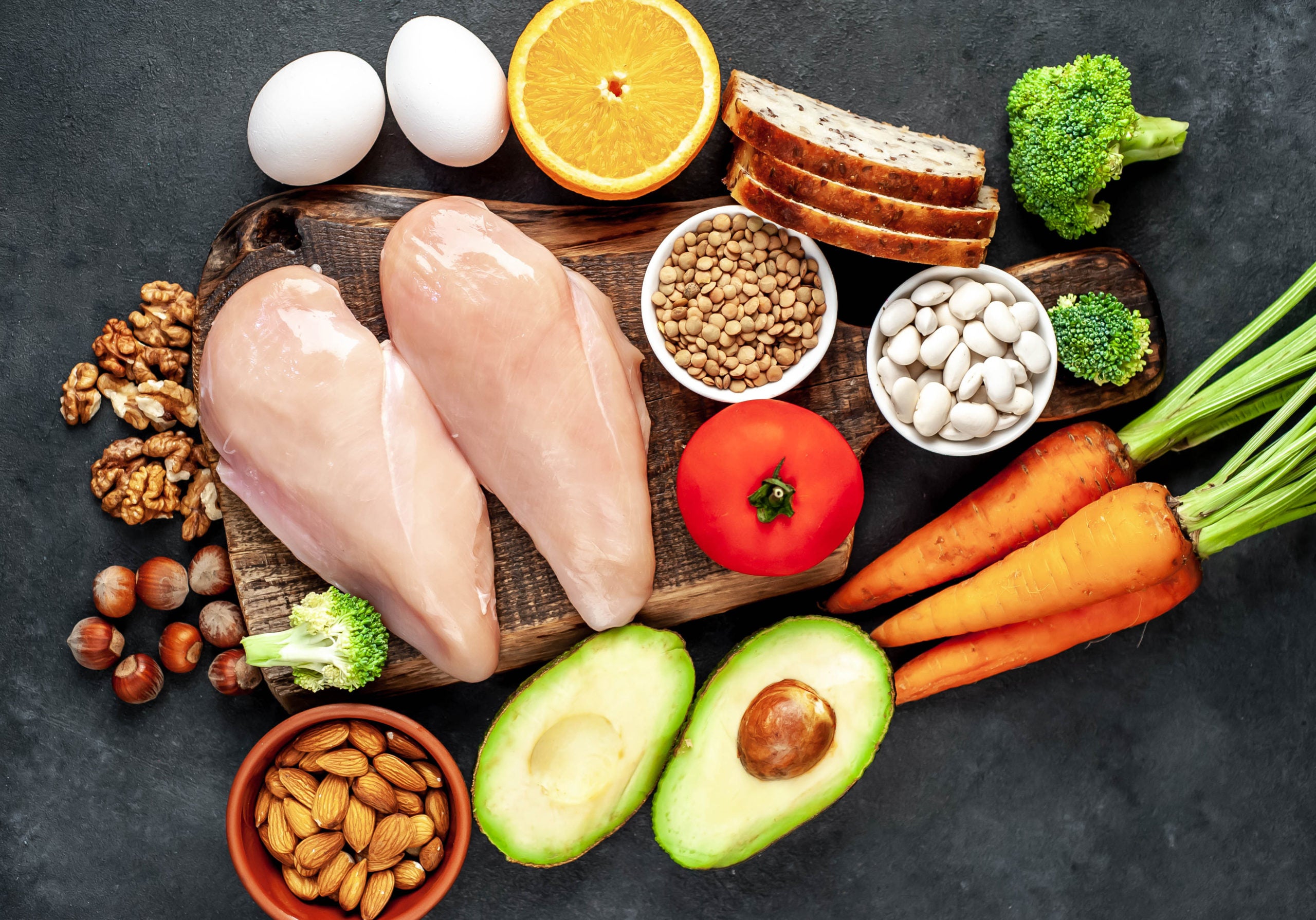 A range of foods high in Niacin (or Vitamin B3) including legumes, nuts, seeds, carrots, chicken, avocado, eggs, grains, broccoli