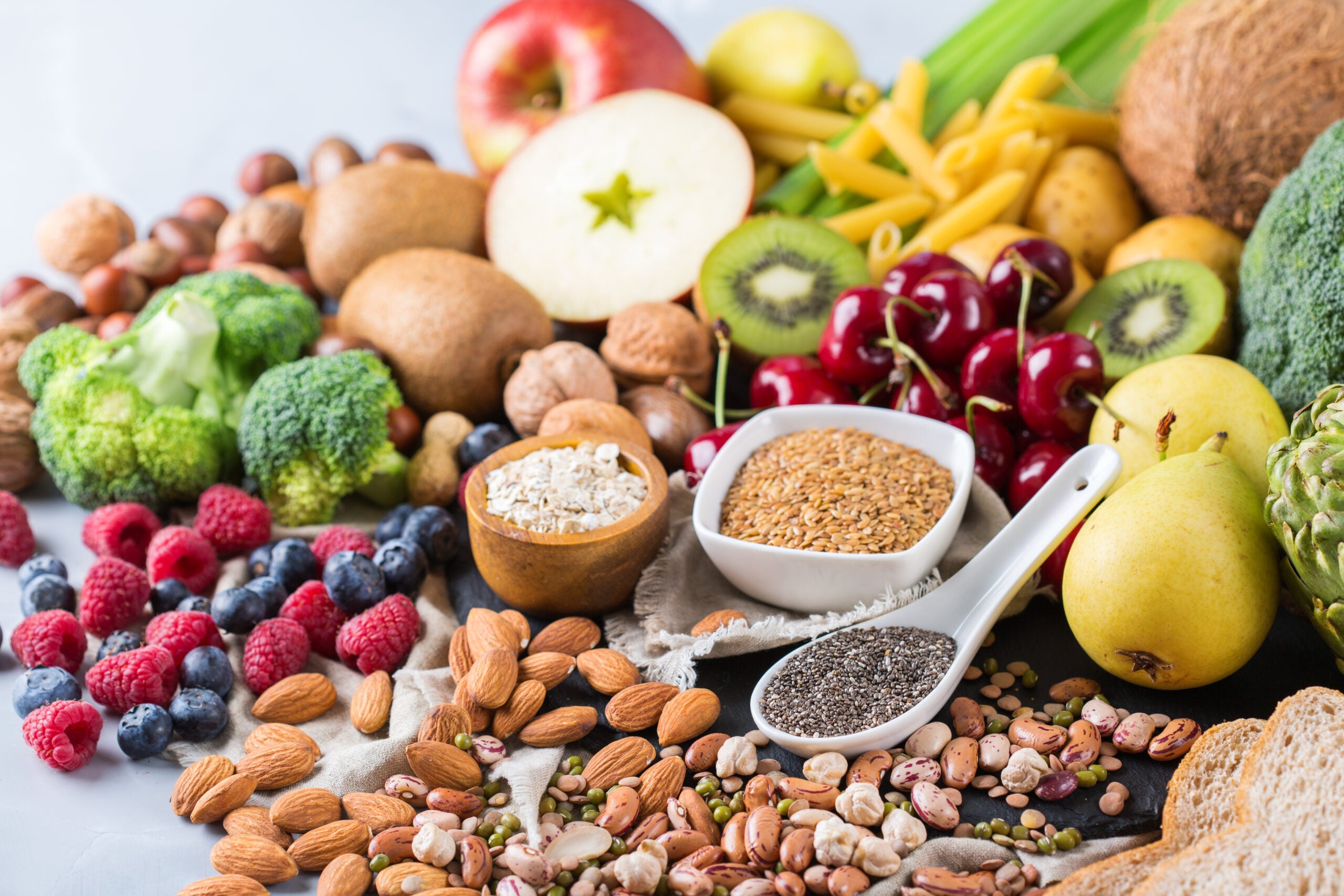a variety of high fiber foods including berries, nuts, seeds, fruits, vegetables, and whole grains