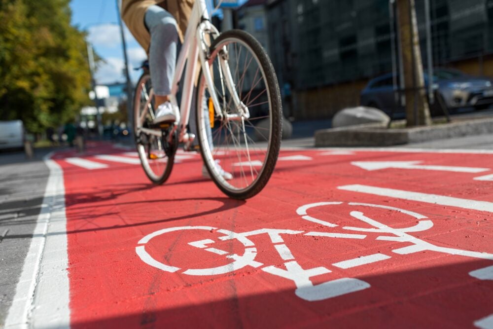 painted protected bike lane with bicyclist riding on it