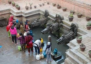 People getting water out of fountain