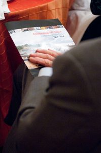 Person holding the program at the Symposium