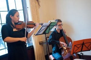 Classical musicians play string instruments at the cocktail party