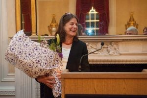 Lisa Berkman accepts an arrangement of flowers