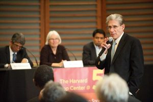 Julio Frenk speaks to crowd and panel
