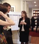 Lisa Berkman talks to fellows at the reception