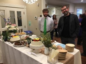 Jason Beckfield and researchers stand near table of desserts