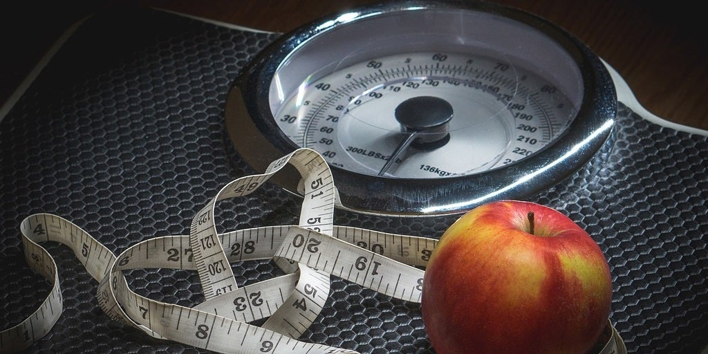 Image of apple, measuring tape, and a scale