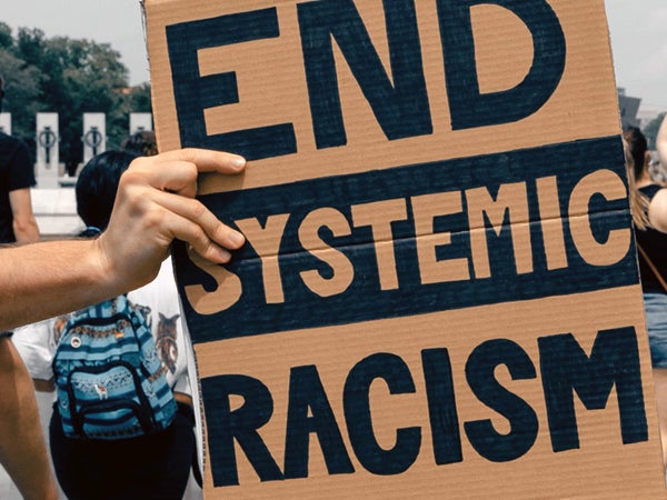 Handwritten sign "End Systemic Racism"