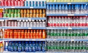 Grocery store shelves of sugary drinks and bottles of water