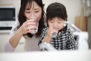 Mom and daughter drinking tap water