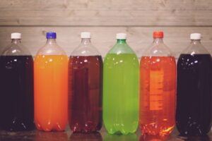 Six bottles of multi-colored sugary drinks