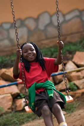 Young girl in red t-shirt swinging