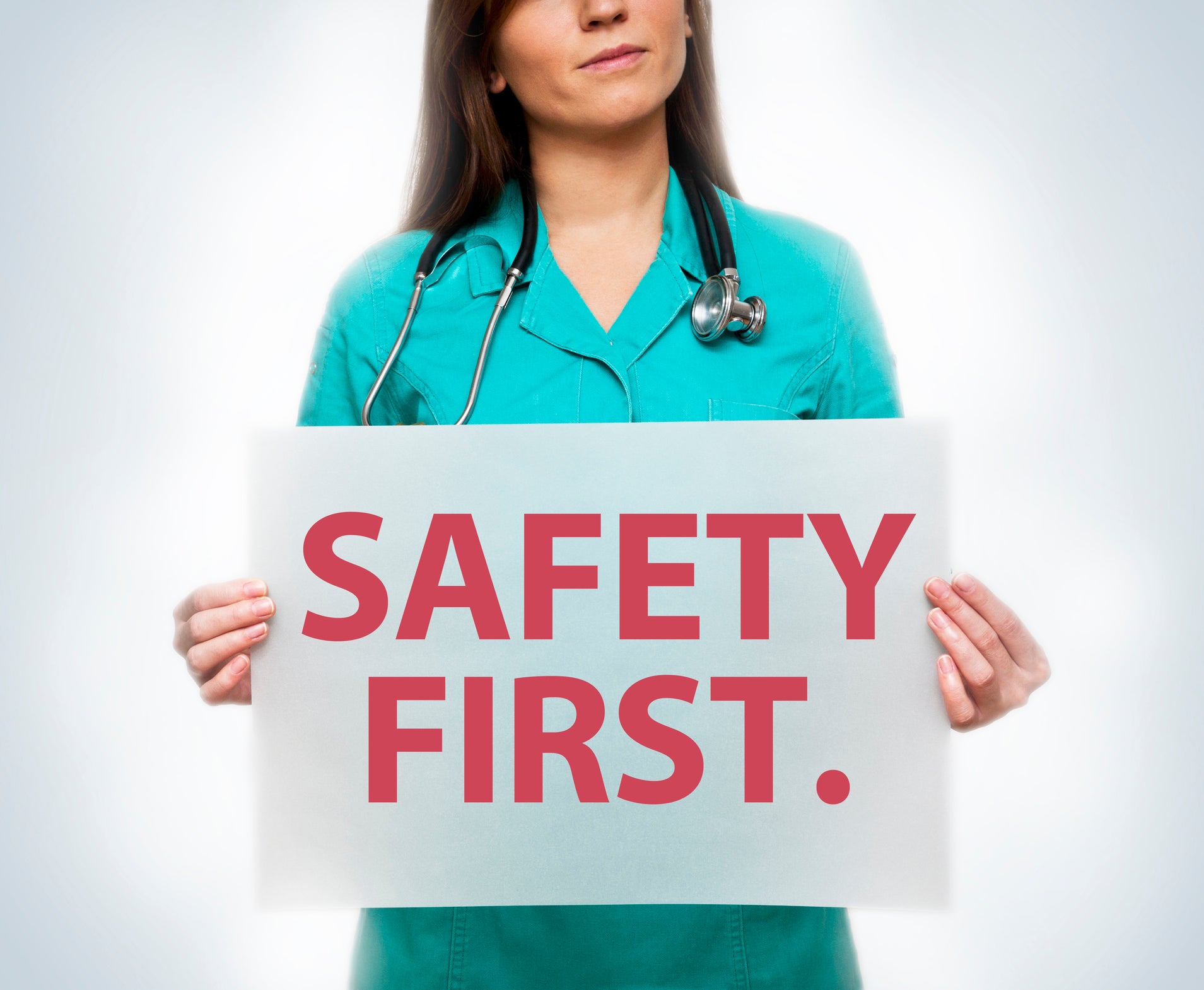 Doctor Holding Safety First Poster