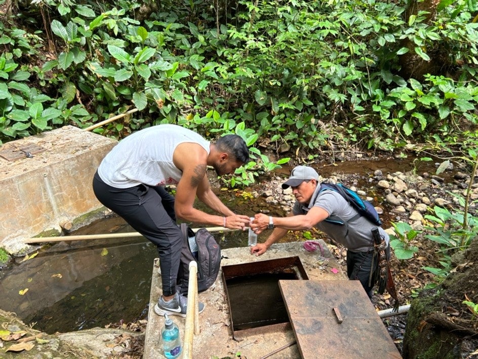 Local water volunteer, “junta de aguas” and I collect water together from local springs for E. coli testing