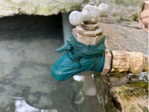 Water tap covered by turquoise cloth