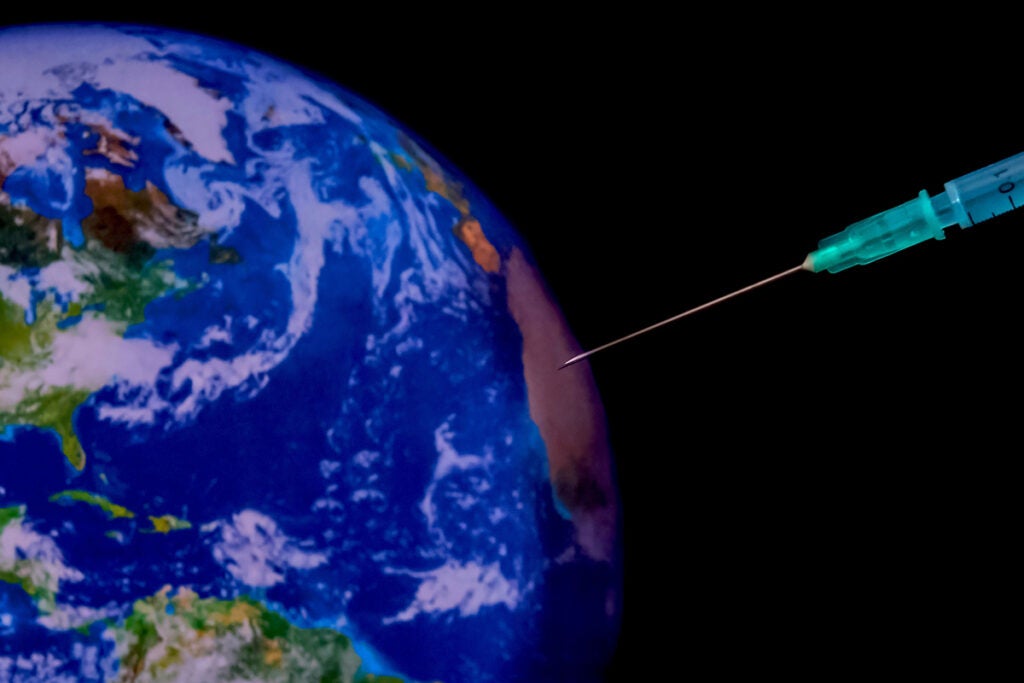 Vaccination needle sticking into the globe