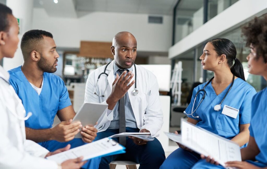 Health care workers sitting in a circle conversing