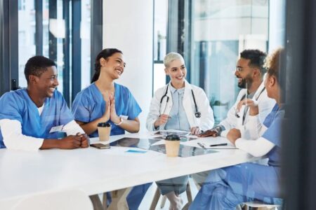 Group of health care workers sitting at a table talking