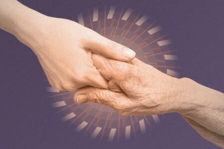 Image of a younger hand reaching out to grasp an older hand