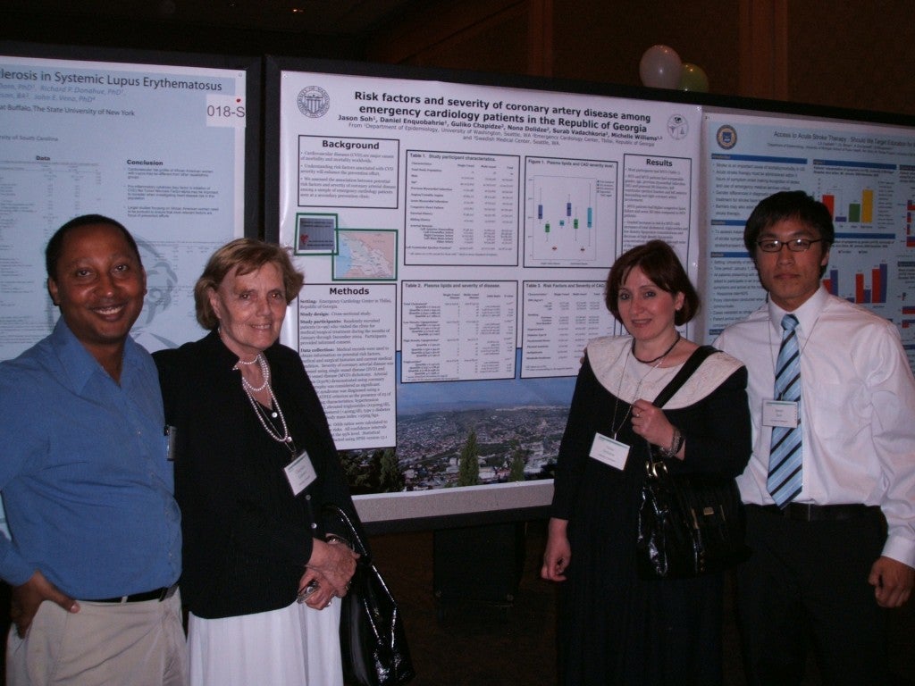 Faculty members from Republic of Georgia (center L to R: Dr. Guliko and Dr. Dolilidze) present collaborative posters with MIRT fellows, Dr. Daniel Enquobahrie (left) and Mr. Jason Soh (right).