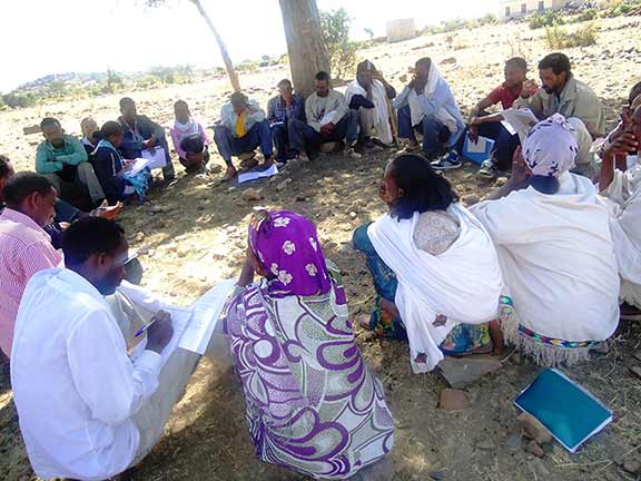 Men and women gather for a participatory community quality improvement meeting in Ethiopia maternal health respectful maternity care