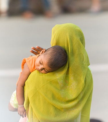 A mother holds her child near the Indian-Pakistan border