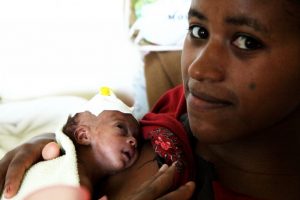 Woman with one month old newborn daughter