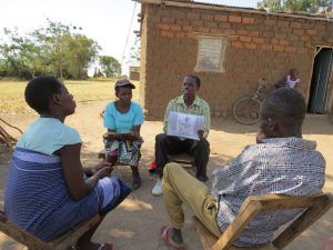 MCSP-trained community health workers Obeid Joseph and Deborah Denis discuss reproductive and maternal health issues with a couple during a home visit